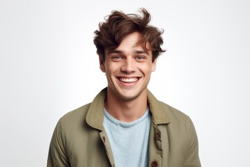 Portrait of a smiling young man looking at camera over white background