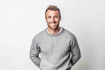 Fototapeta premium Portrait of a handsome smiling man in sweater on a white background