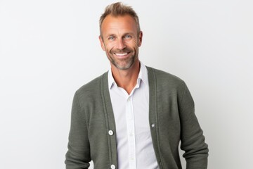 Fototapeta premium Portrait of handsome mature man smiling at the camera while standing against white background