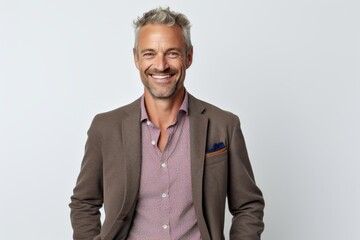 Portrait of handsome mature man with grey hair smiling at camera.