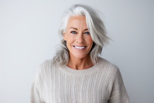 Portrait of a beautiful mature woman smiling at camera isolated on a white background