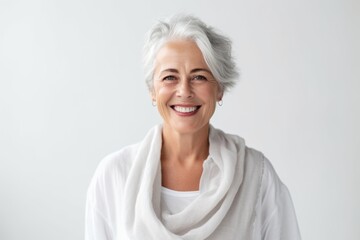 Portrait of a happy senior woman smiling at the camera over white background