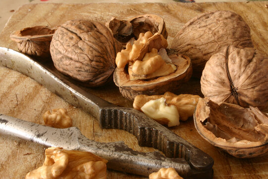Walnuts and nutcracker on a wooden board