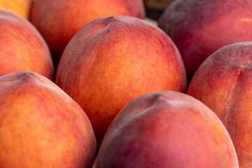 Ripe fresh peaches on a wooden table