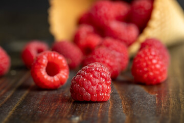 Ripe red raspberries in a crispy waffle cone