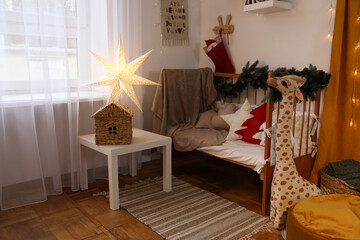 Cozy children's room with bed, toys and Christmas decor. Interior design