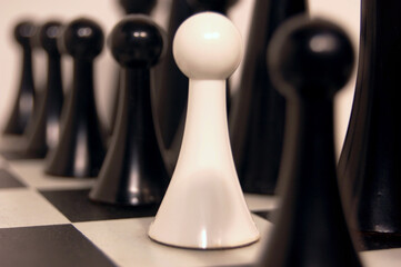Chess game, one white pawn among black