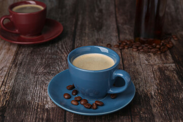 Fototapeta premium Delicious coffee and beans on wooden table