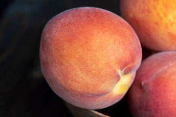 Ripe fresh peaches on a wooden table