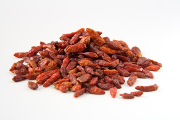 Bird eye chili pepper, isolated on white. Shallow depth of field, focused on the centre of the pile.