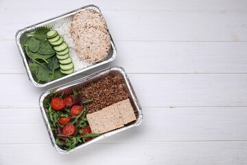 Containers with different fresh products on white wooden table, flat lay. Space for text