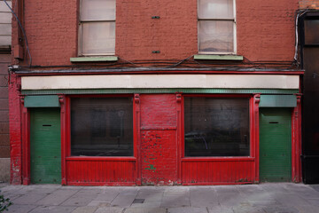 Run down old building with peeling paint and vacant shuttered store