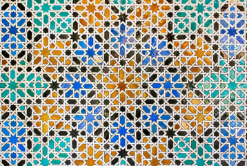 Intricate and colorful mosaic geometric pattern made of glazed tiles in the historic Casa de Pilatos in Seville, Andalucia, Spain - obrazy, fototapety, plakaty