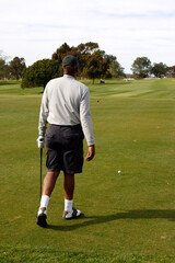 Obraz premium Sunny day in the golf park, Golfer walking