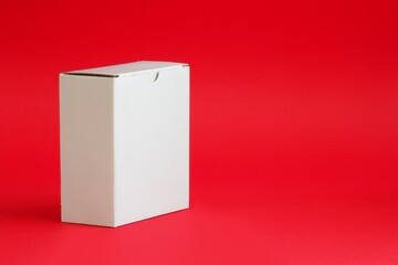 White Cardboard box on red background