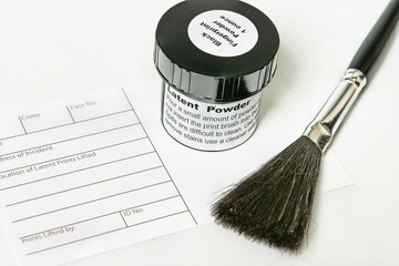 Crime scene investigation tools.   Latent fingerprint powder, fingerprint incident sheet and brush...