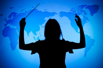silhouette of female conductor on the blue world map