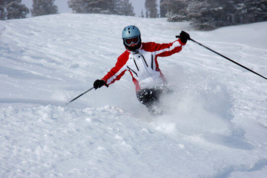 Woman skiing fresh tracks in Utah powder