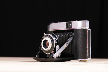 Antique film folding camera and old film, close-ups
