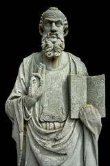 An ancient stone statue on the island of Torcello, in Venice, Italy, holding open a book and making...