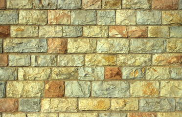 Rustic wall in warm sandstone, Malta.