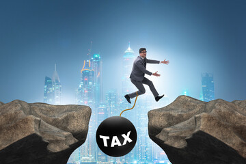 Concept of tax burden with businessman over chasm