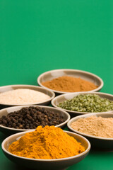 Various spice bowls agains a plain background