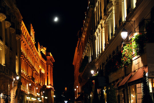 Illuminated street in Paris France with bright moon