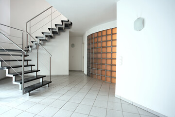 A modern room with stairs and flagstones