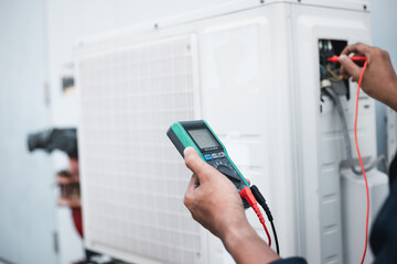 Air conditioner technicians use a multimeter to check electricity and Part of the preparation to...
