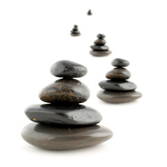 Stacks of balanced stones with shadow on white background. Very shallow DOF