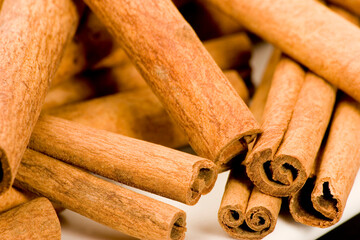 Cinnamon sticks against a plain background