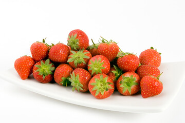 Fresh Strawberrys set against a plain background