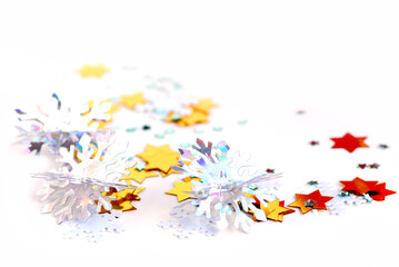 Christmas background of scattered gilittering confetti on white