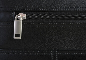 Detail of zip on a leather briefcase.