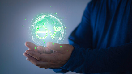 Man show Ev icon light bulb, Energy EV concept, Hand of human holding global with EV icons, Green sustainable energy produced from renewable resources.