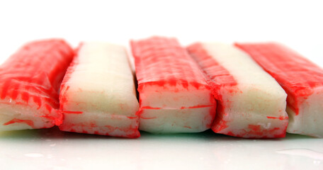 A Line of crabsticks on a white background © Designpics