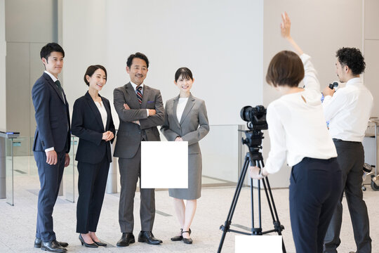 Photographers and company employees shooting a corporate image Landscape at the lobby of the company