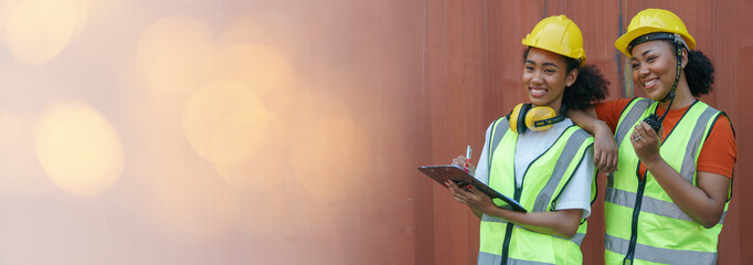 group of two happy african american woman container worker smiling together in warehouse logistic...