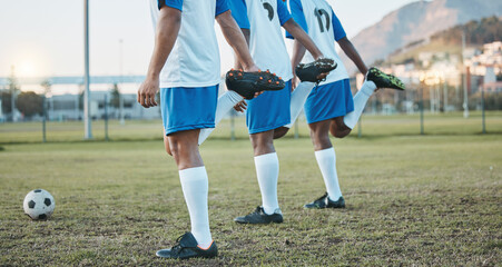Fototapeta premium Soccer, team sports and stretching legs on field for fitness, exercise and training outdoor. Football ball, pitch and club for athlete men together for sport competition, wellness and muscle warm up
