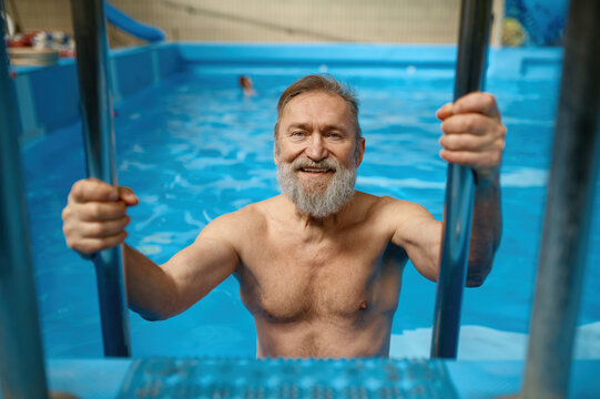 Portrait Of Good-looking Fit Senior Man Getting Out From Swimming Pool