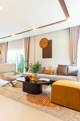 Scandinavian style living room interior, modern living room interior with brown leather pillow and art piece on wall.