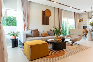 Scandinavian style living room interior, modern living room interior with brown leather pillow and art piece on wall.