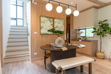 Interior design of modern dining room, wooden table and brown chairs, scandinavian home decoration.