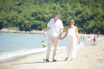 young couple walking on the beach and enjoy to travel in summer