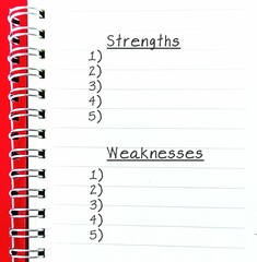 notebook with lists of STRENGTHS and WEAKNESSES, concept of self reflection list making - identify...
