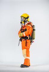 Side view of firefighter wearing yellow hard hat standing holding fire hose with both hands on white background.