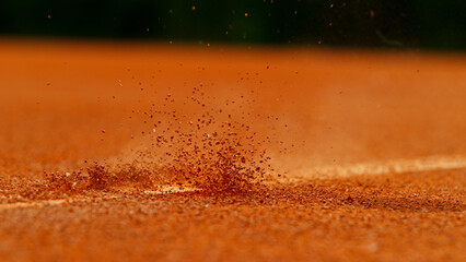 Close up of Tennis ball ping on clay court inside or outside white line - 609296290