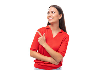 portrait of a cute young european brunette lady in a red t-shirt actively gesturing with her index finger towards the wall