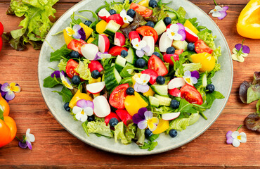 Tasty summer salad with edible flowers